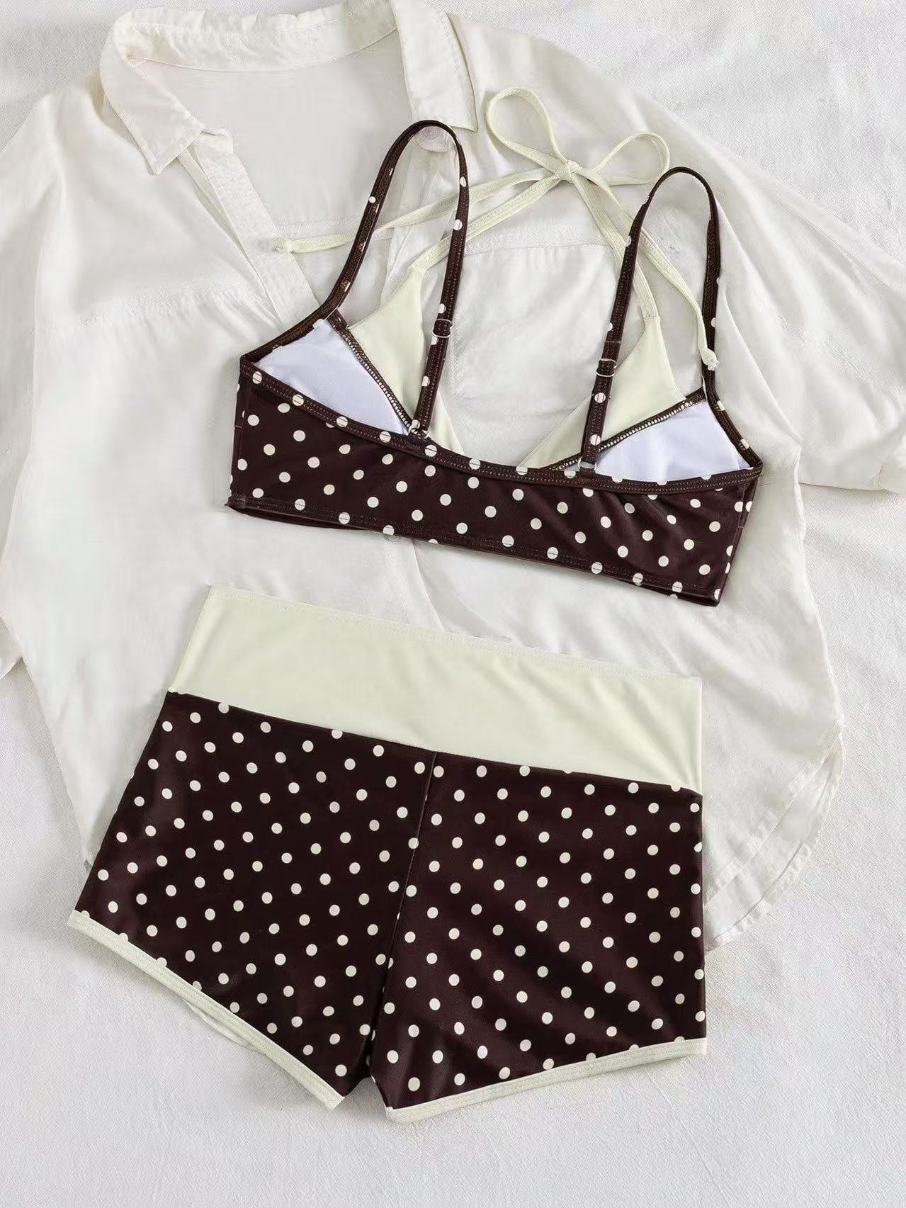 Brown and white polka dot bikini set featuring a halter triangle top and high-waisted boyshort bottoms.