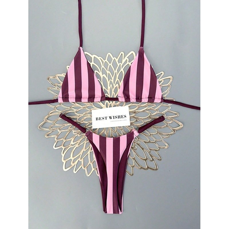 Pink and maroon vertical striped halter triangle bikini set with side-tie bottoms.