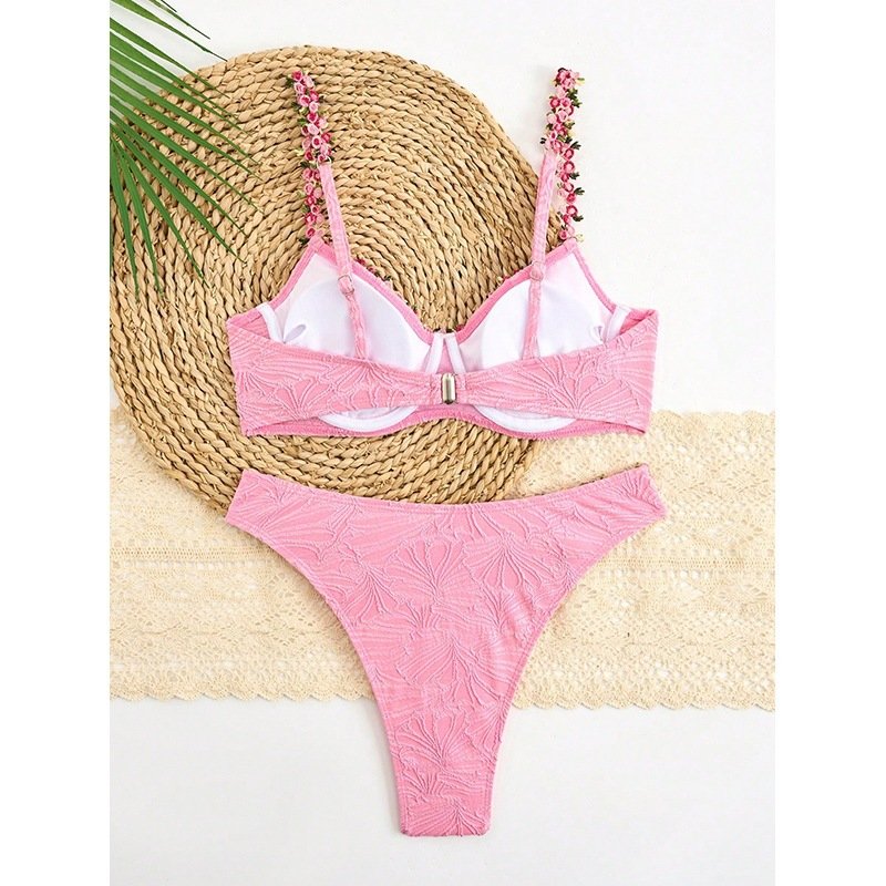Pink floral embellished underwire bikini set with adjustable straps and textured bottoms.