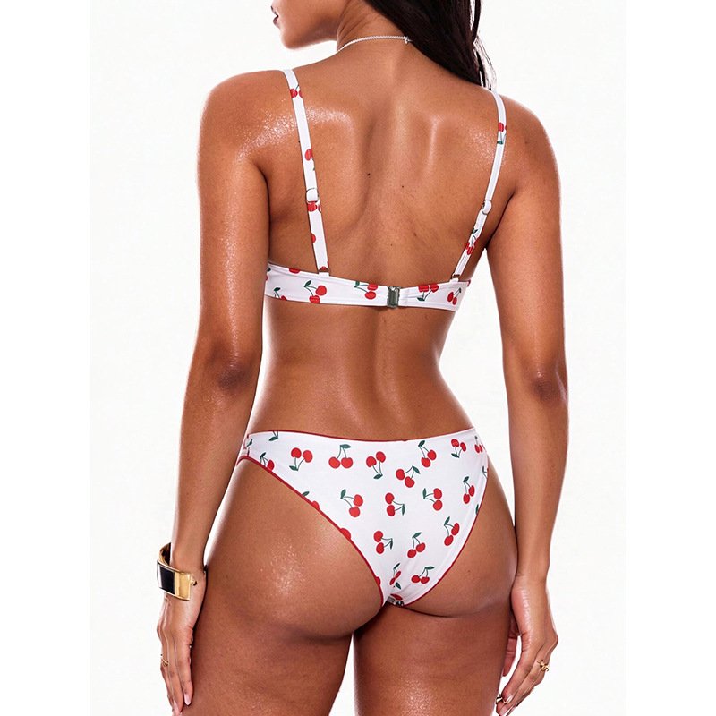 Back view of a white cherry print bikini set with adjustable straps and a hook closure.