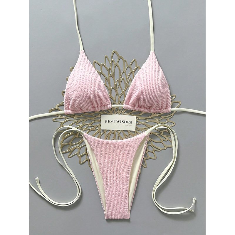 Pink textured reversible string triangle bikini set with adjustable white side ties and halter straps.
