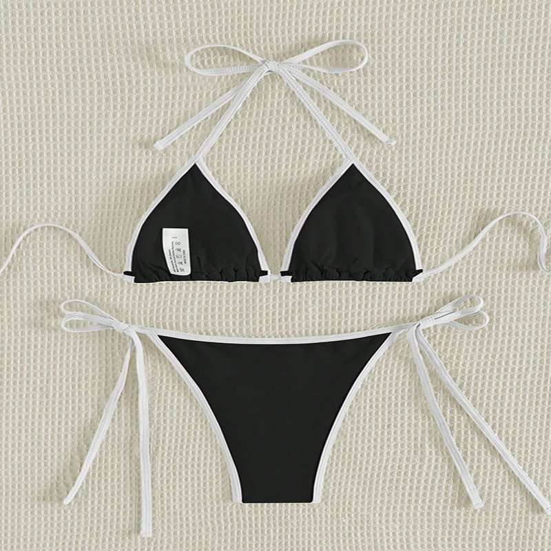 Black triangle bikini set with white contrast piping, halter neck ties, and adjustable side ties on bottoms.