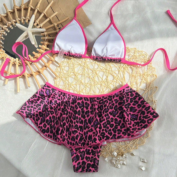 Pink and white triangle halter bikini top with matching leopard print ruffle skirt bottom set.
