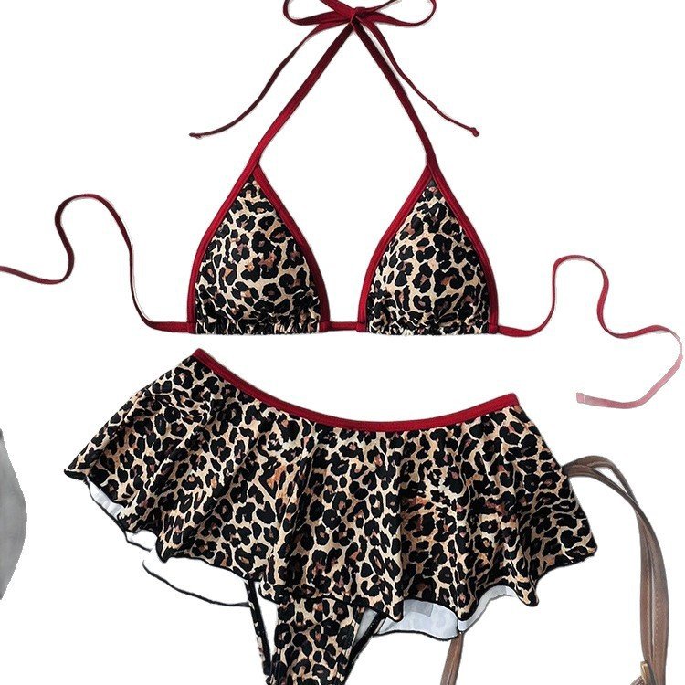Leopard print triangle halter bikini top with red trim and matching ruffle skirt bottom set.