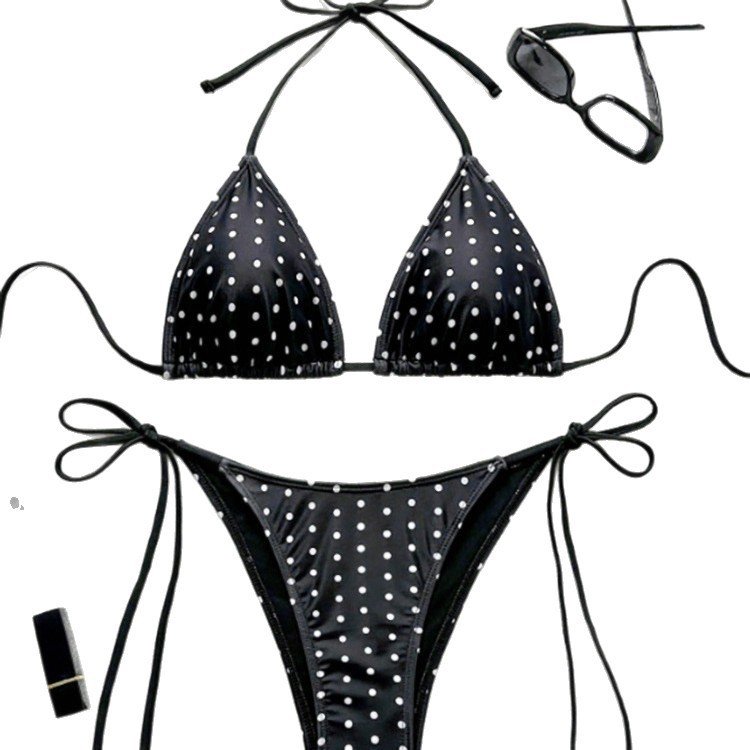 Black and white polka dot triangle bikini set with halter tie top and side-tie bottoms.