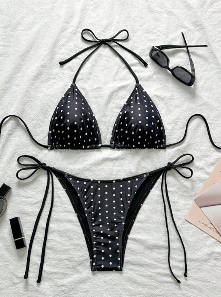 Black and white polka dot triangle bikini set with halter tie top and side-tie bottoms.