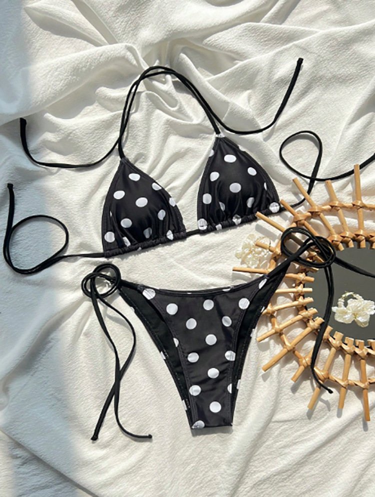 Black and white polka dot tie-strap triangle bikini set with adjustable side ties.