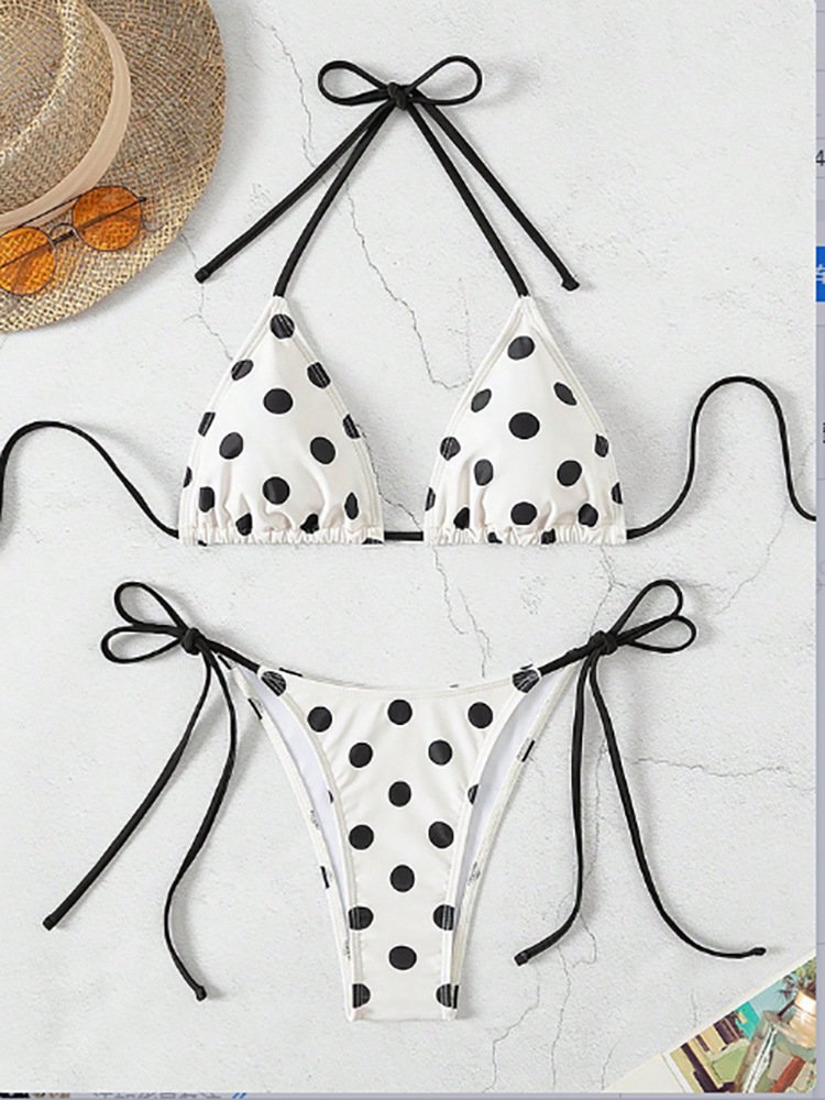 White polka dot triangle bikini set with black halter neck and side tie straps.