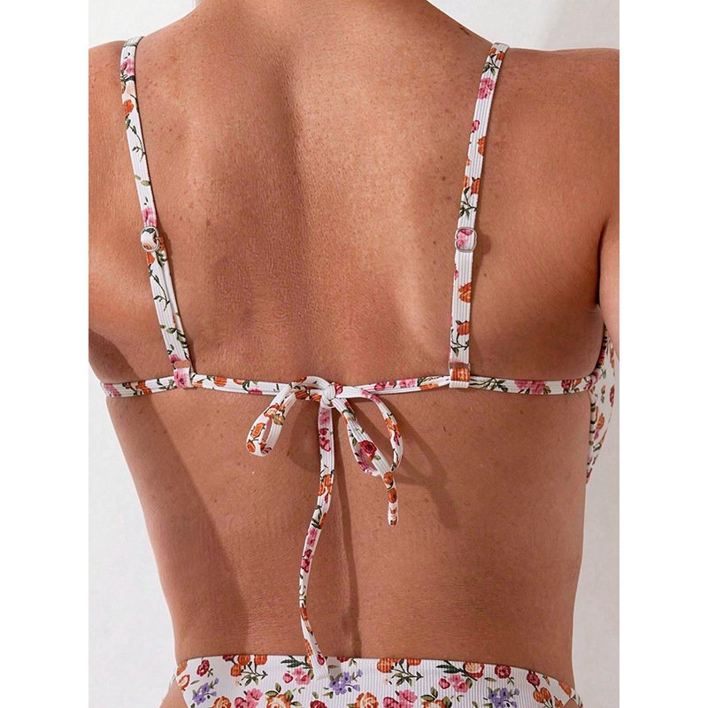 Back view of a floral print triangle bikini top featuring adjustable straps and a tie-back closure.