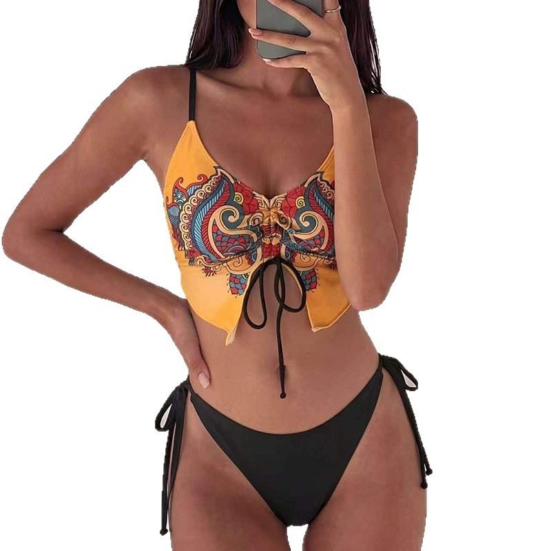 Yellow and black patterned tie-front camisole bikini top with matching black side-tie bottoms.