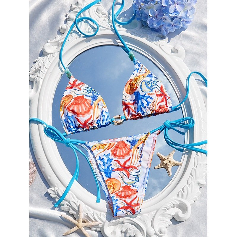 A two-piece tie-strap triangle bikini set featuring a colorful seashell print with blue strings.