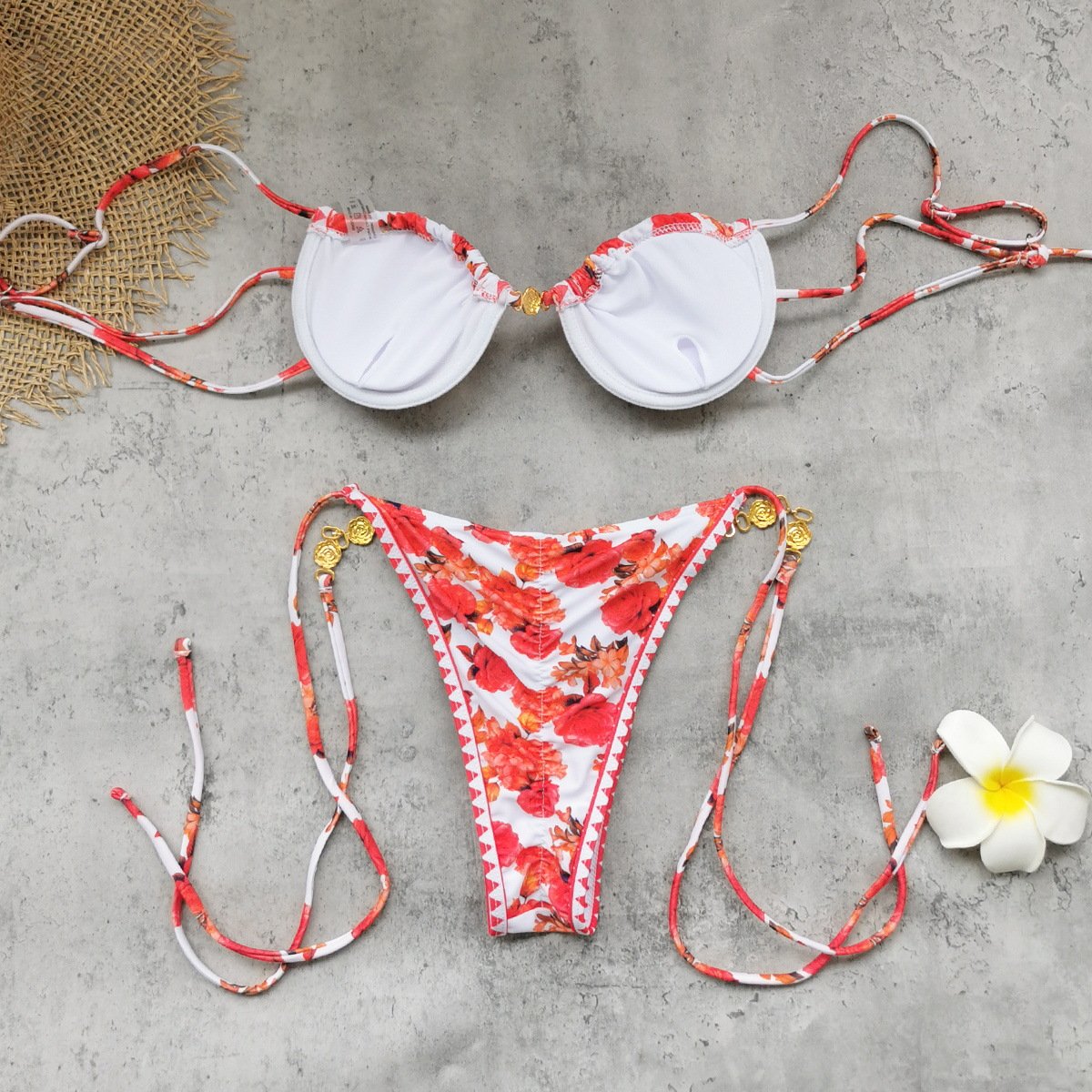 A white and red floral underwire triangle bikini set with tie-side bottoms and gold hardware.