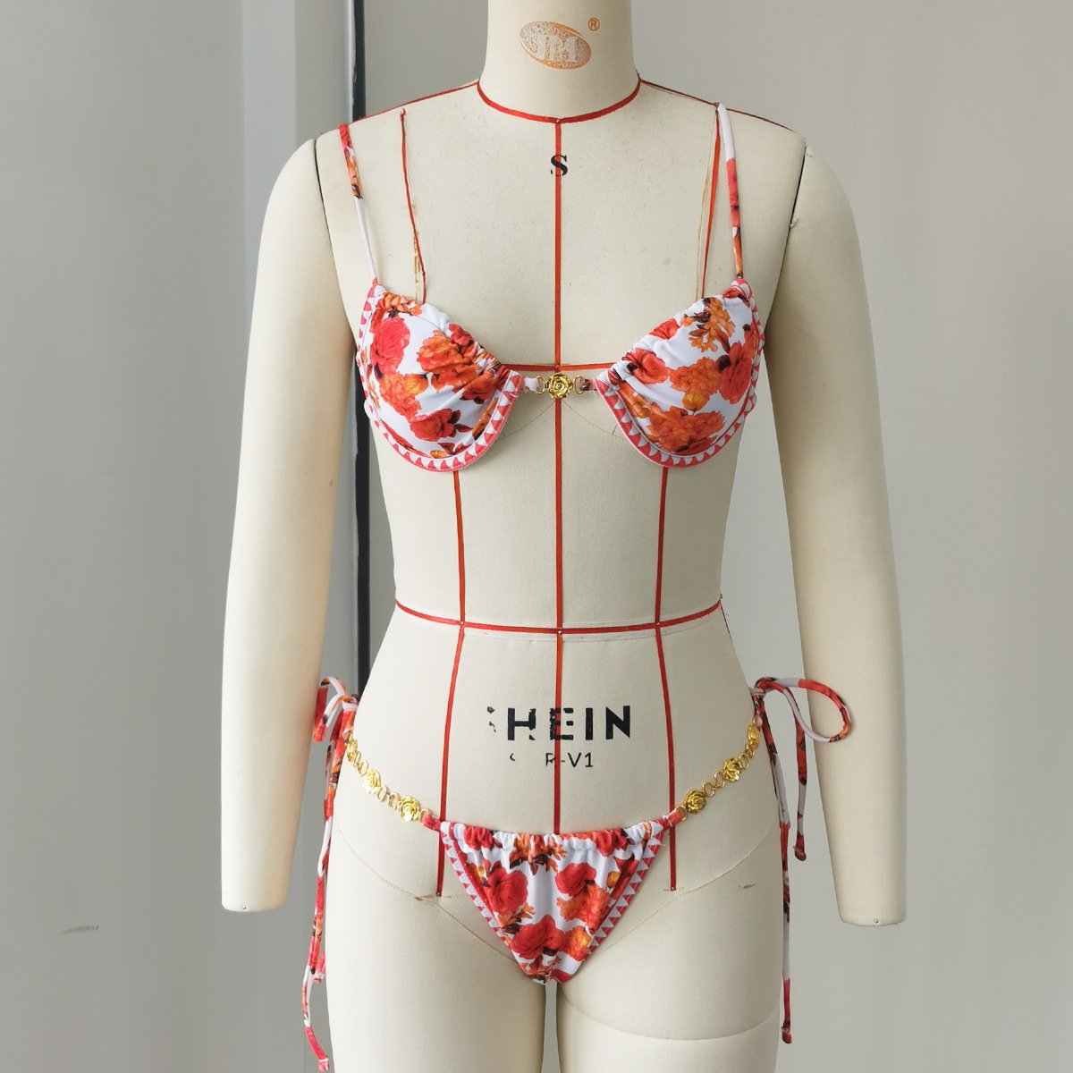 Floral print underwire triangle bikini set with tie-side bottoms and gold chain detail.