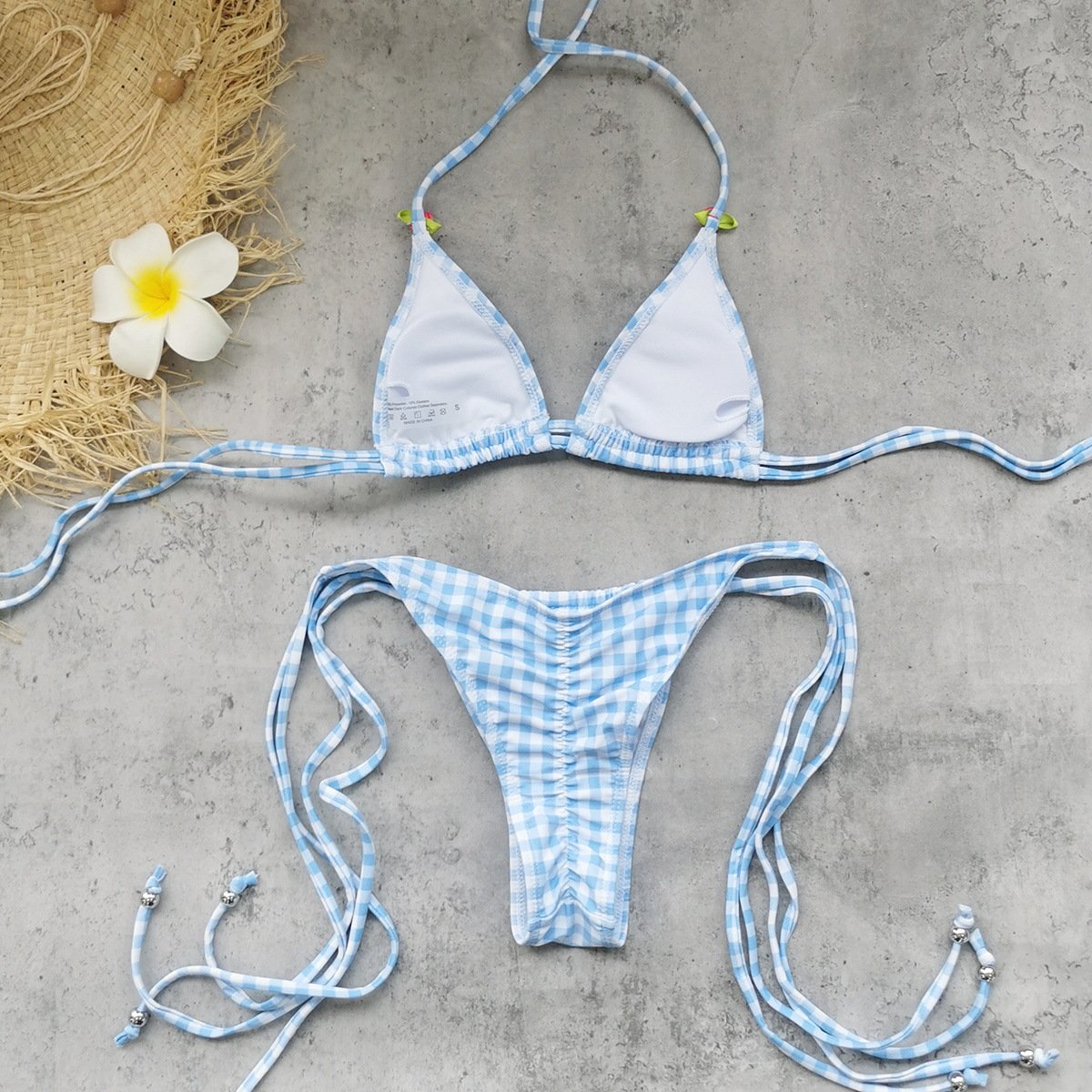 Blue and white gingham triangle bikini set with tie-side bottoms and adjustable straps.