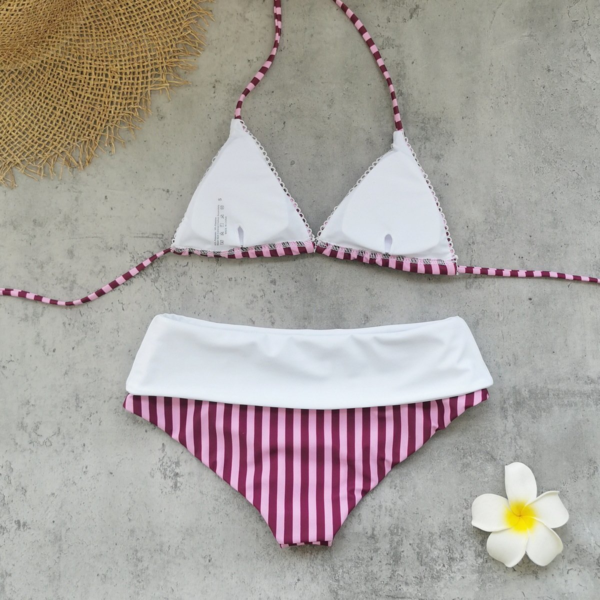 White triangle bikini top with striped halter ties and scalloped edges, paired with striped bottoms featuring a white