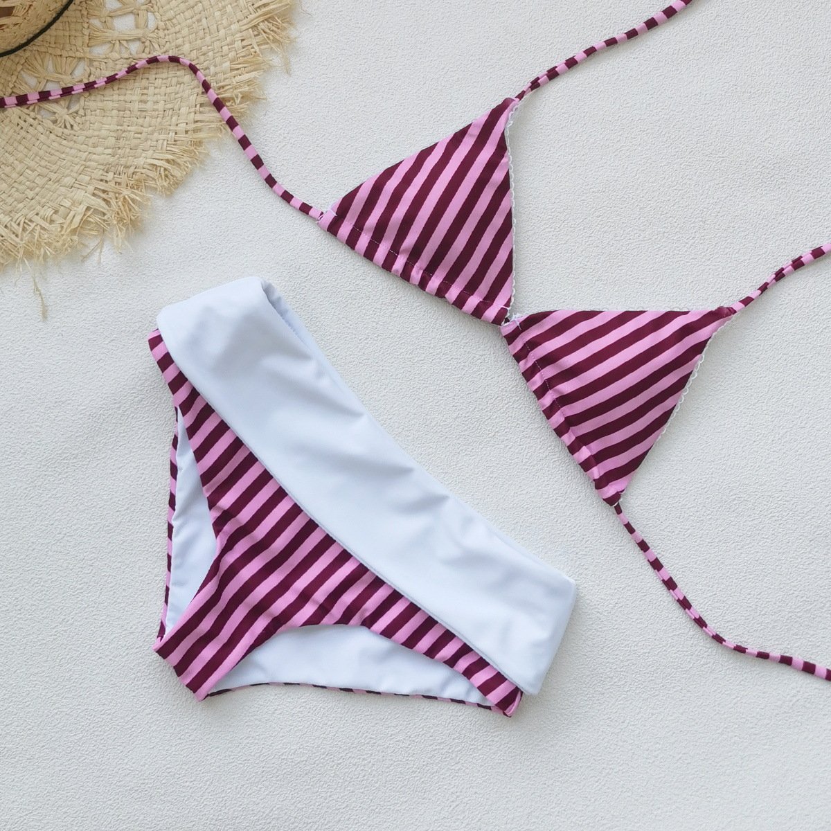 Pink and maroon striped halter triangle bikini set with fold-over white waistband bottoms.