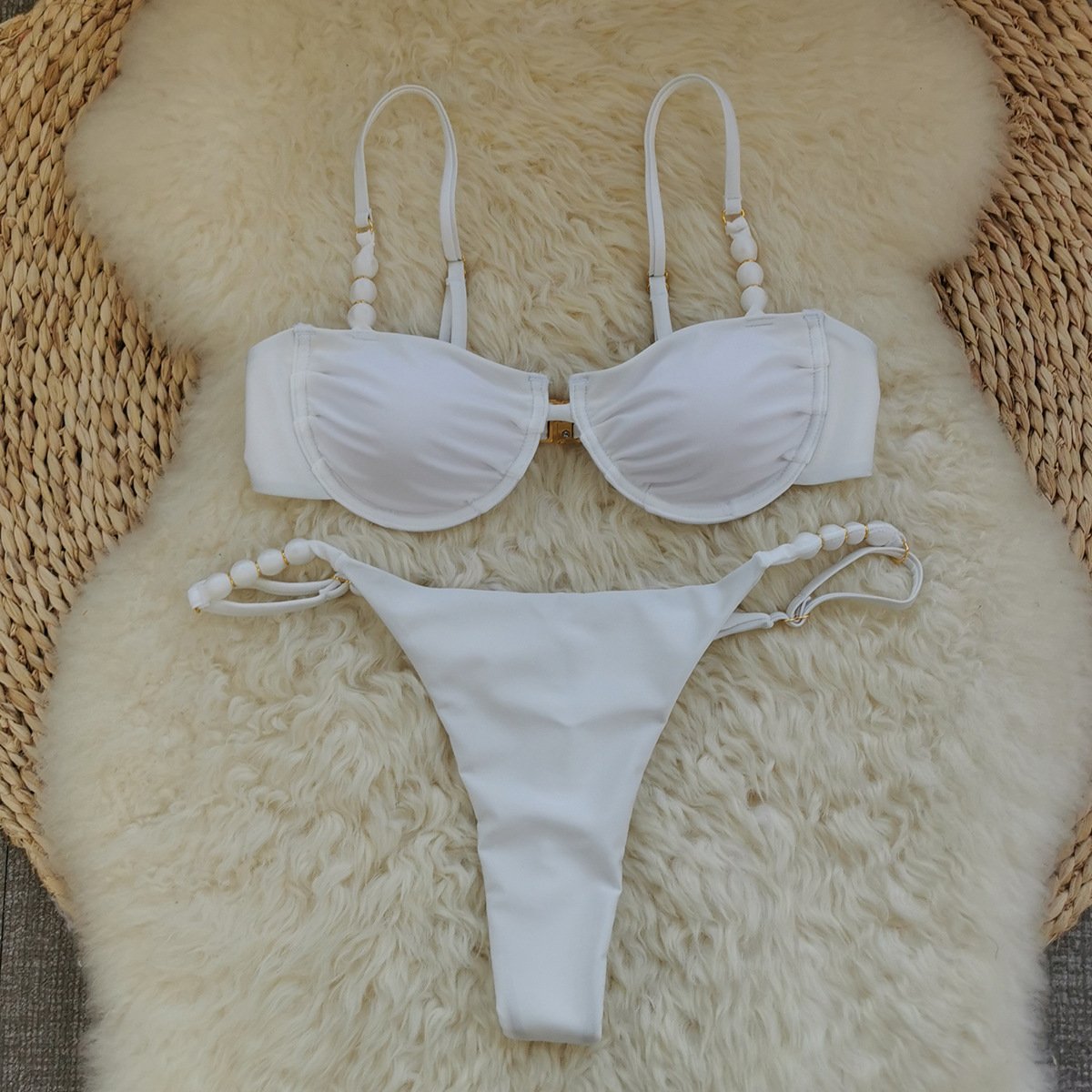 White two-piece bikini set with underwire top, front clasp, and beaded adjustable straps.