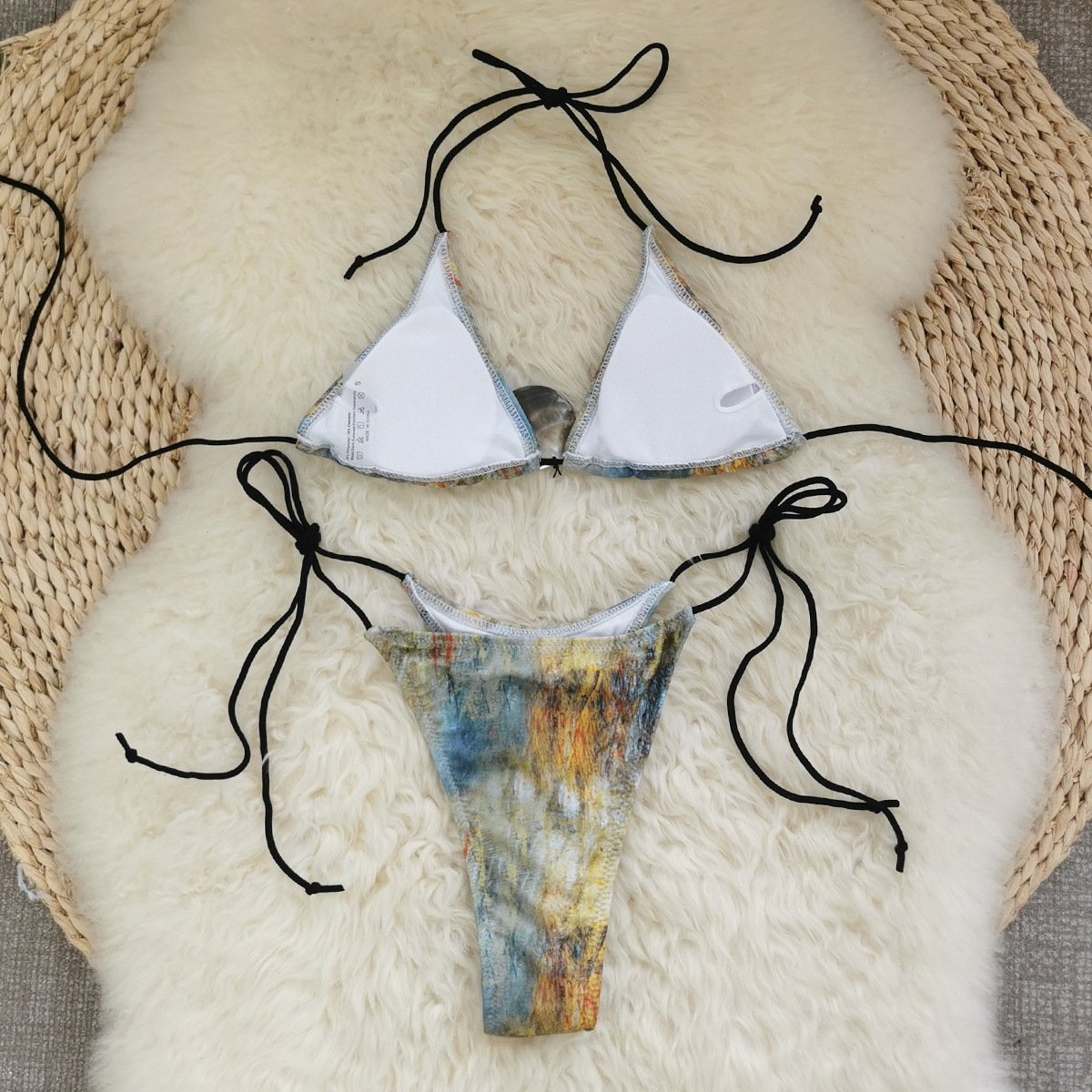 Abstract print triangle string bikini set with black halter ties and high-cut bottoms.