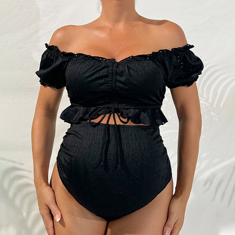 Black off-the-shoulder maternity two-piece swim set featuring ruffled short sleeves, a ruched bodice, drawstring peplum waist, and high-waisted