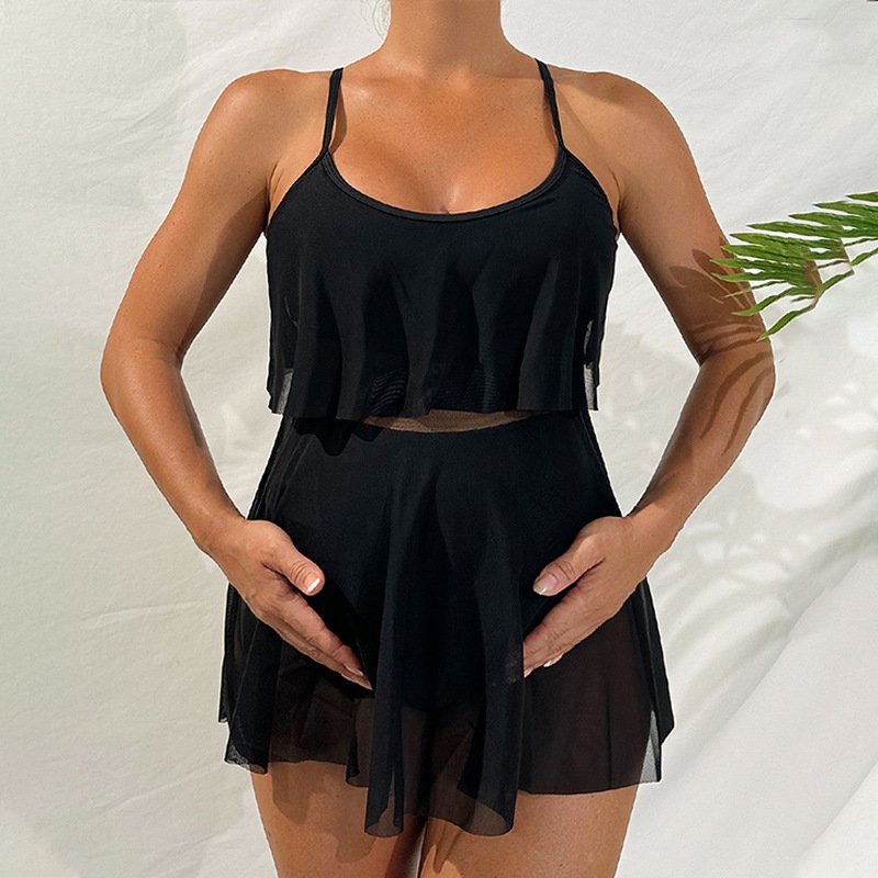 Black maternity tankini set with a scoop-neck crop top and high-waisted bottoms featuring a sheer pleated skirt overlay.