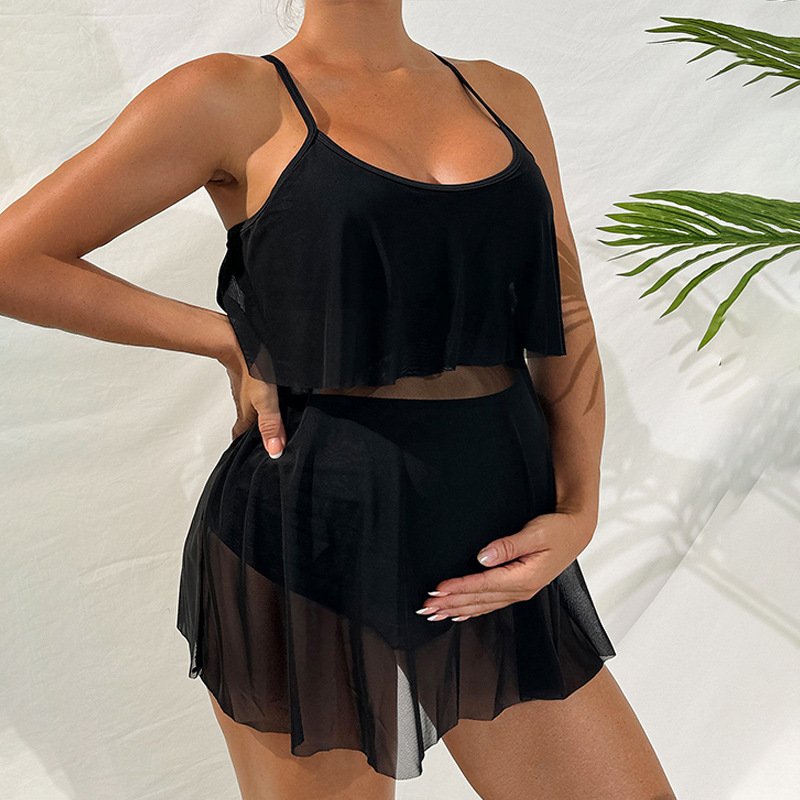 Black maternity tankini set featuring a sheer overlay skirt and adjustable straps.