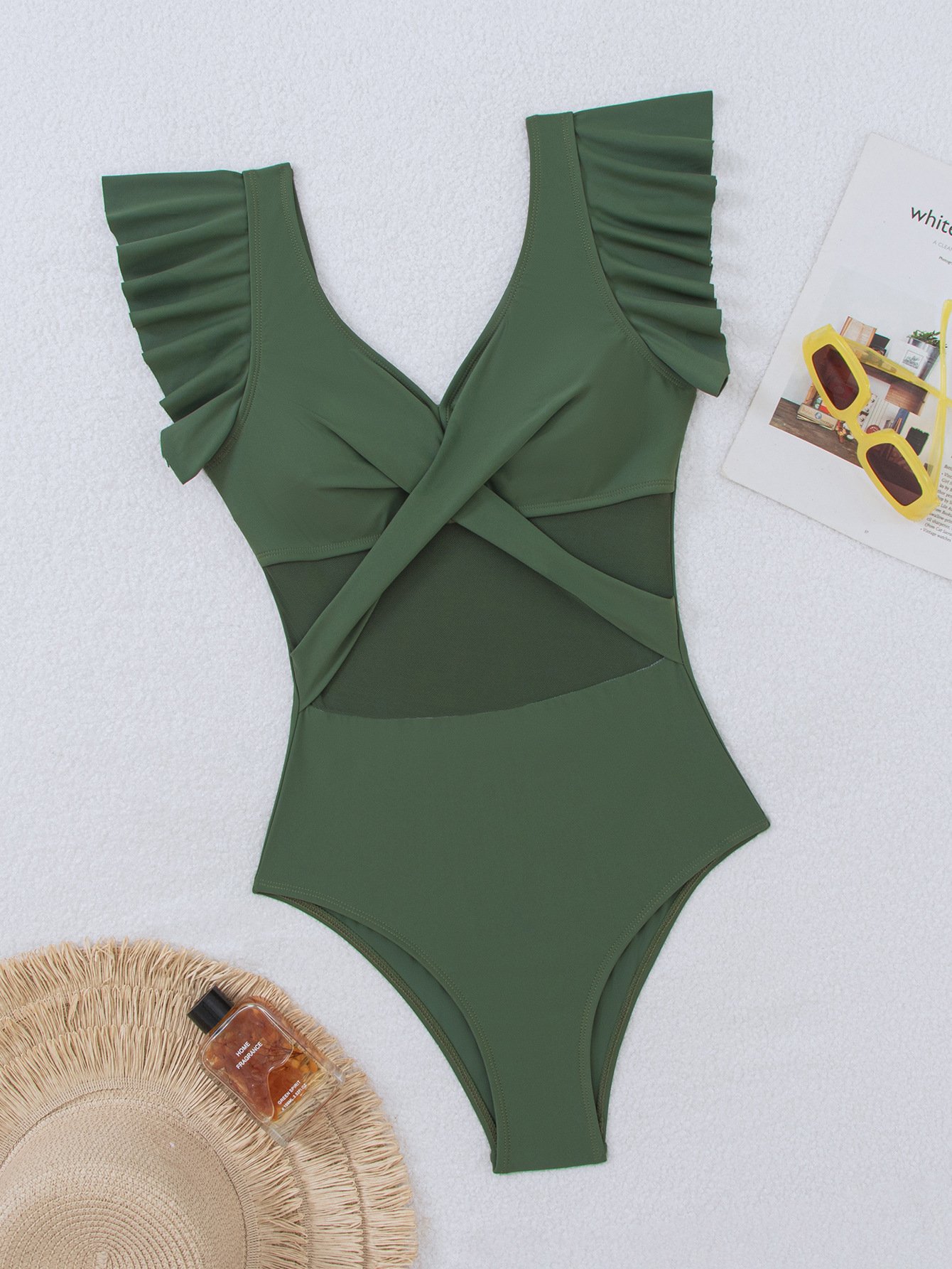 Green one-piece swimsuit featuring ruffled cap sleeves, a deep V-neckline, twist-front bodice, and sheer mesh waist panels.