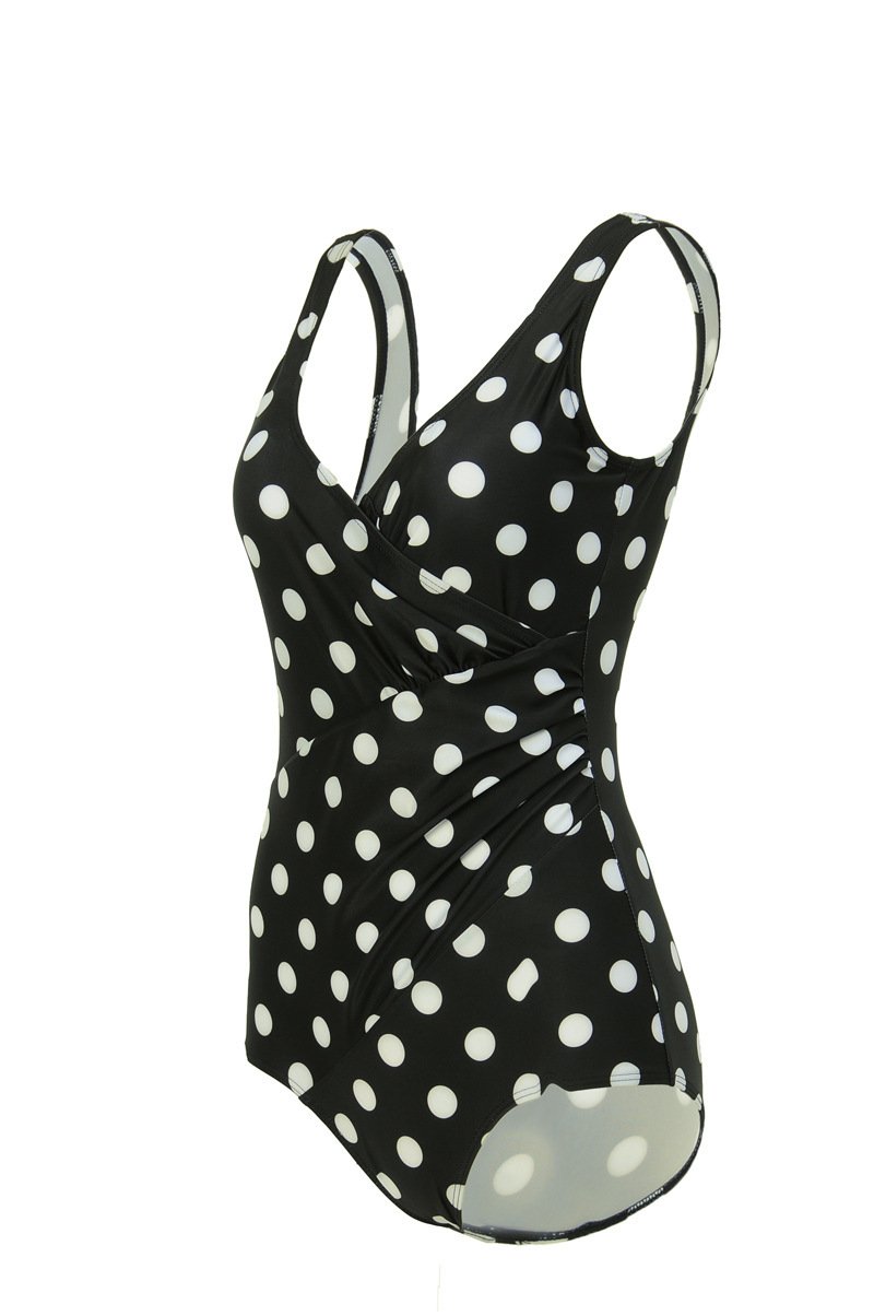 Black one-piece swimsuit with white polka dots, featuring a wrap-front bodice and wide straps.