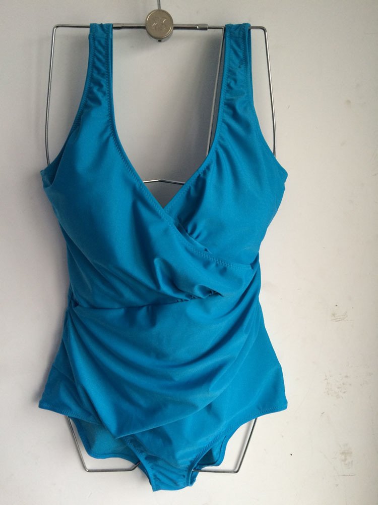 Blue one-piece swimsuit featuring a deep V-neckline, wrap-front bodice, and ruched waist detail.