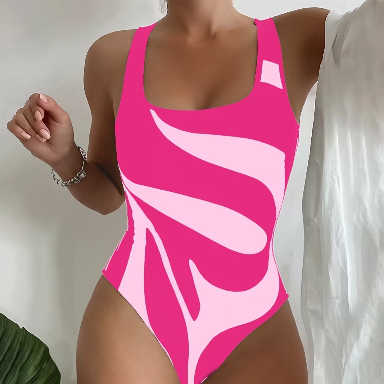 Pink and light pink abstract print one-piece swimsuit with scoop neck and wide straps.