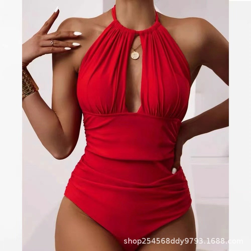 Red one-piece swimsuit featuring a halter neckline with a keyhole cutout and horizontal ruching.