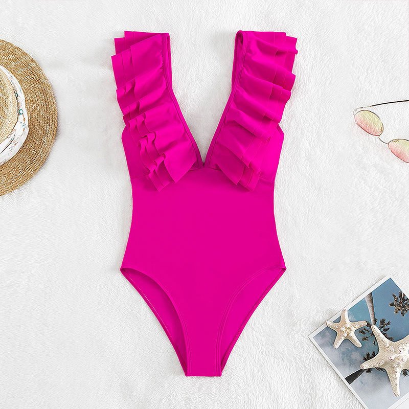 Pink one-piece swimsuit featuring a deep V-neckline and wide ruffled straps.