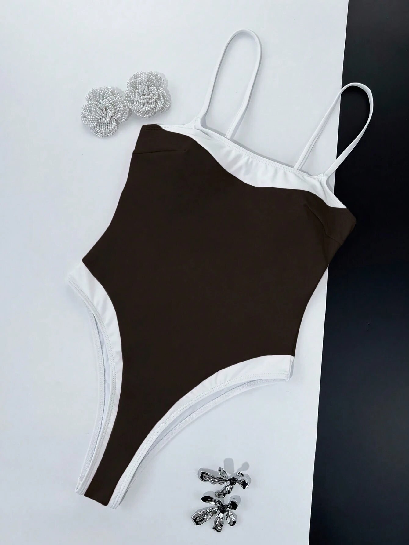 Brown and white contrast trim high-cut one-piece swimsuit with adjustable spaghetti straps.