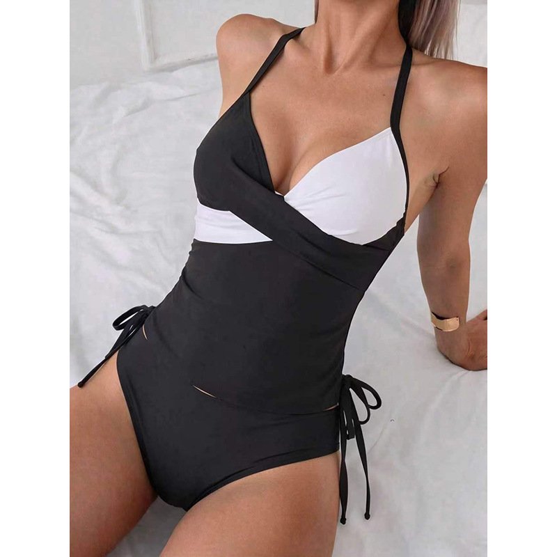 Black and white colorblock wrap halter one-piece swimsuit with side ties.