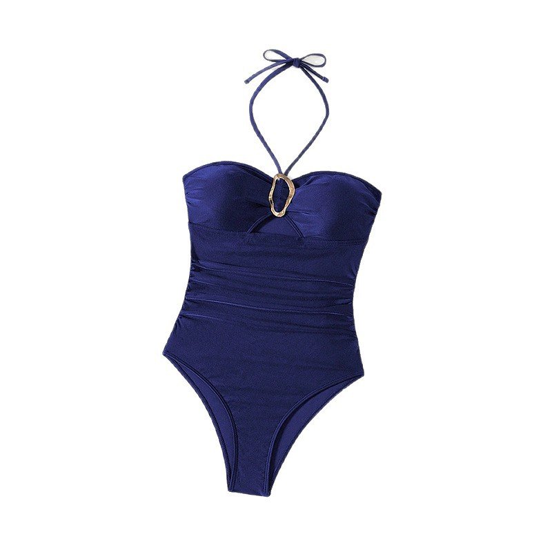 Navy blue one-piece swimsuit with halter neck ties, gold ring detail, and ruched bodice.