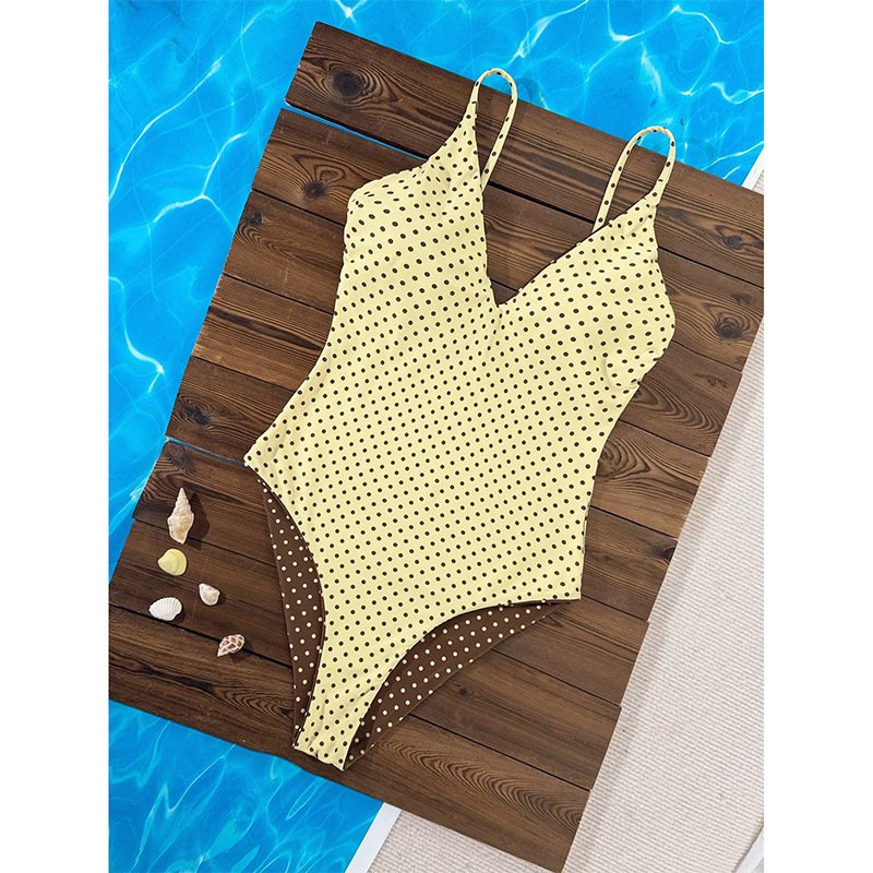 Yellow and brown polka dot reversible V-neck one-piece swimsuit with thin straps.