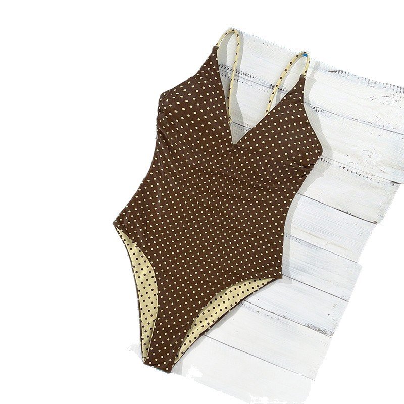 Brown and cream reversible polka dot one-piece swimsuit with a deep V-neckline and thin adjustable straps.