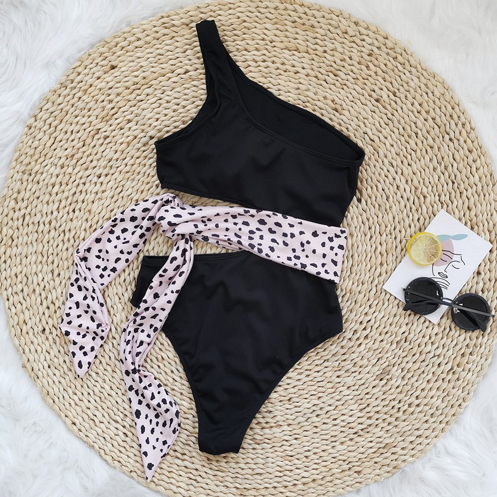 Black one-shoulder cutout one-piece swimsuit with a contrasting leopard print tie belt.