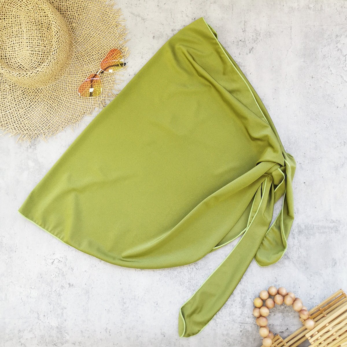 Olive green tie-wrap skirt with matching trim and side knot detail.