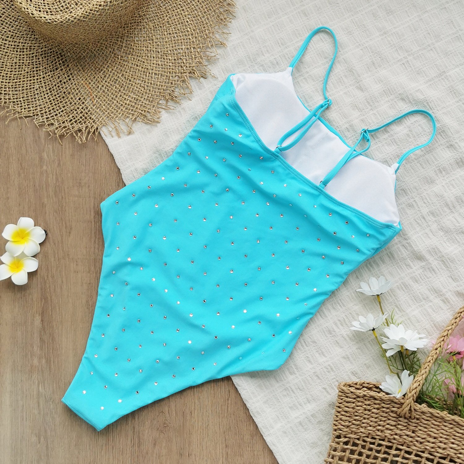 Turquoise rhinestone embellished one-piece swimsuit with adjustable spaghetti straps and high-cut legs.