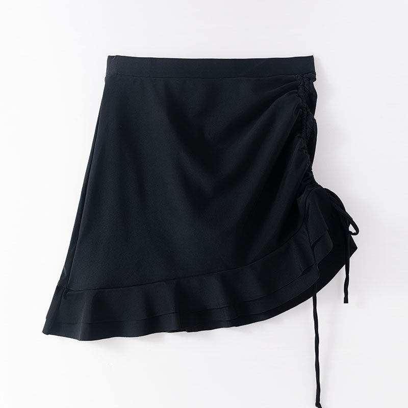 Black high-waisted swim skirt featuring side ruching, a drawstring tie, and a ruffled hem.