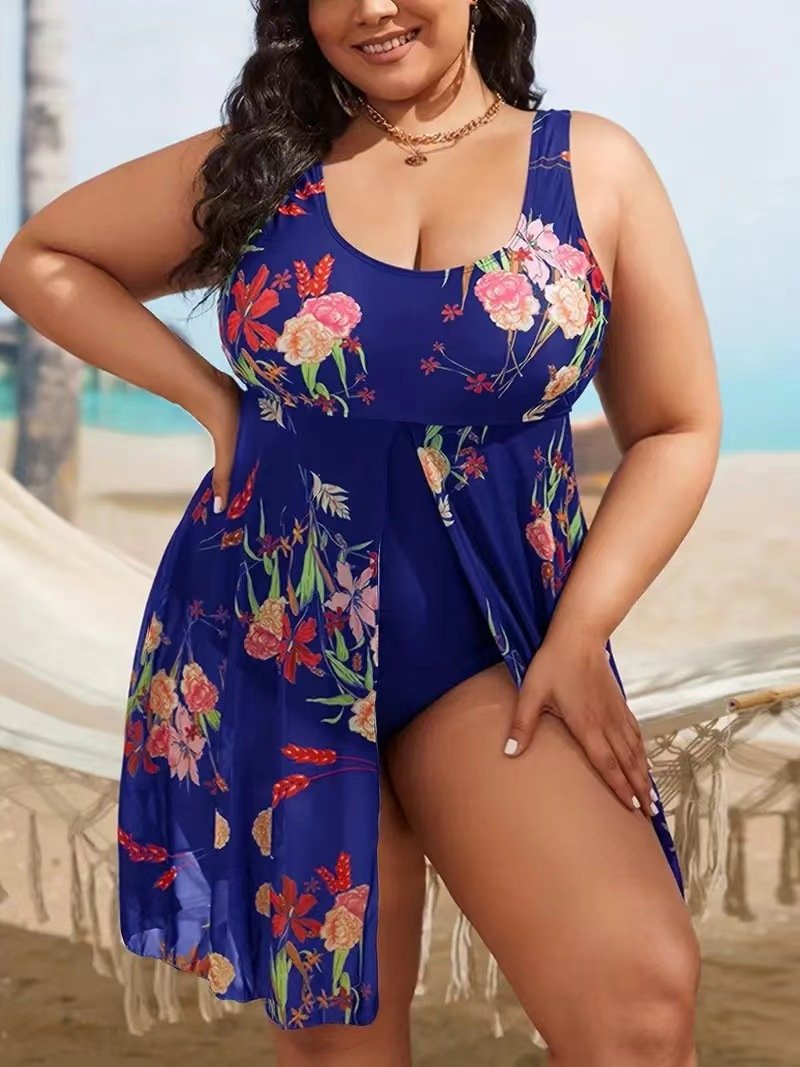 Blue floral plus-size tankini set with scoop neck, wide straps, and attached flowy skirt.