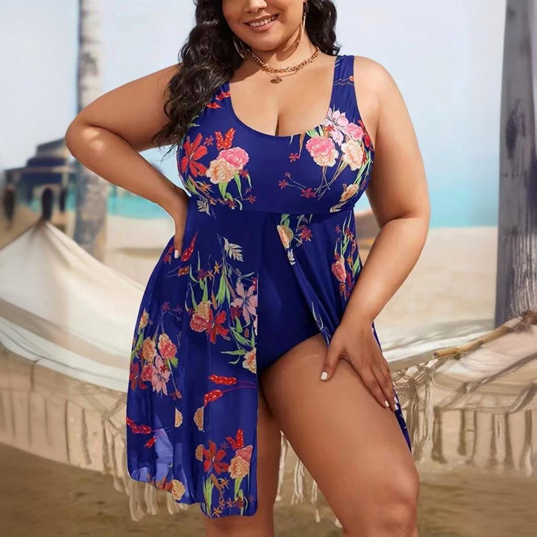 Blue floral plus-size tankini set with wide straps, scoop neckline, and attached flowy skirt overlay.