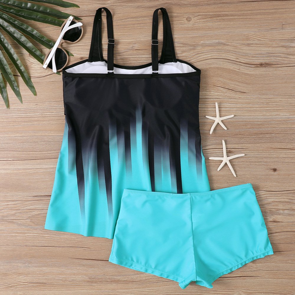 Plus size two-piece swimwear set featuring a black and teal ombre tankini top with adjustable straps and matching