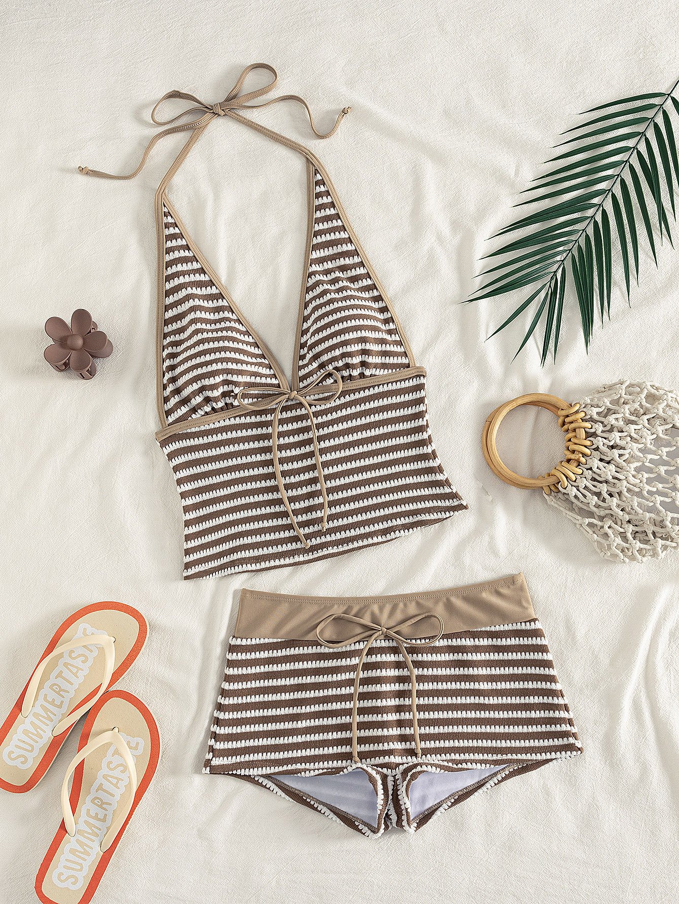 Brown and white striped two-piece swim set featuring a halter crop top with tie-front and matching drawstring shorts.
