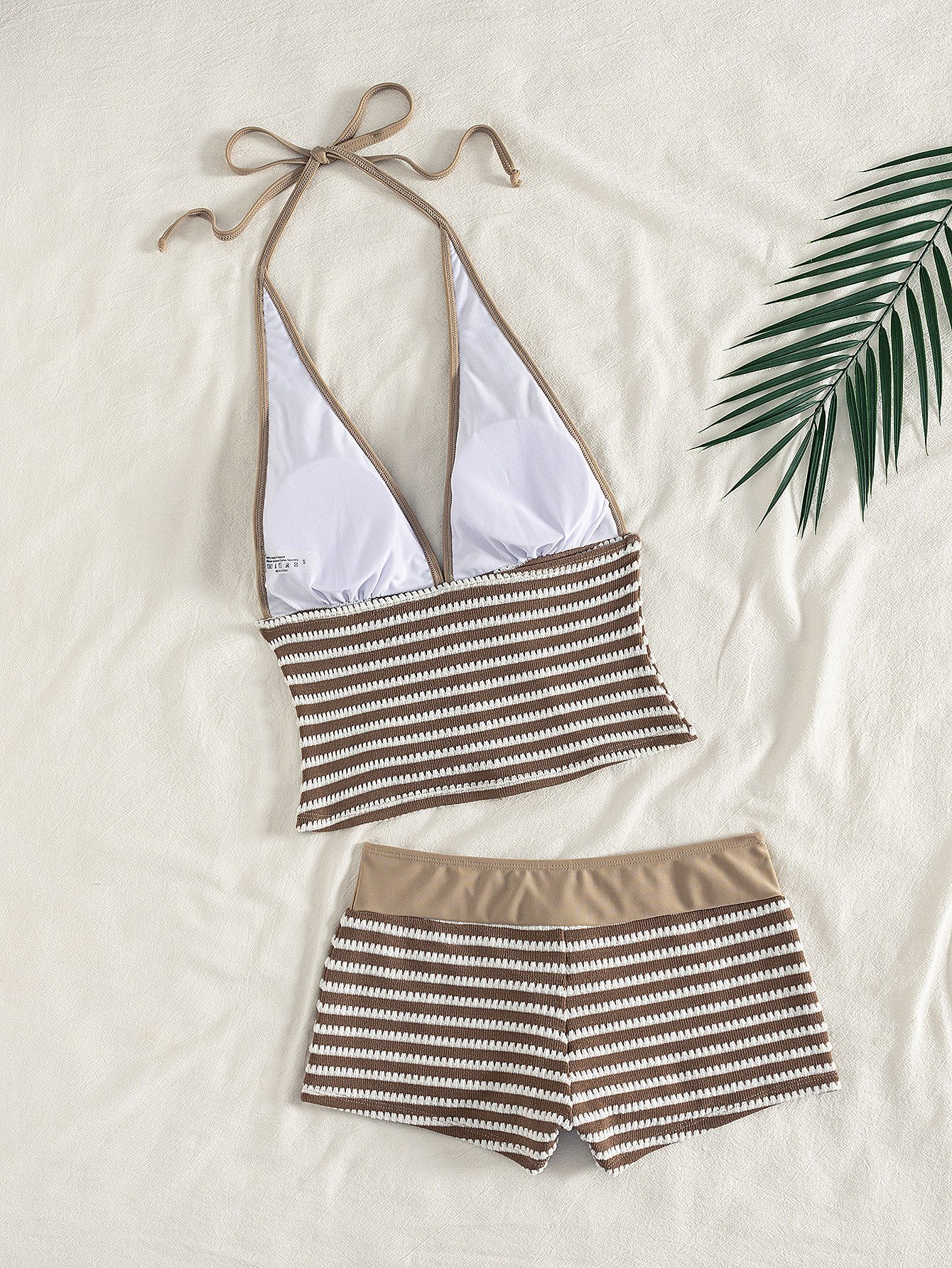 Brown and white striped two-piece swim set featuring a halter crop top and drawstring shorts.