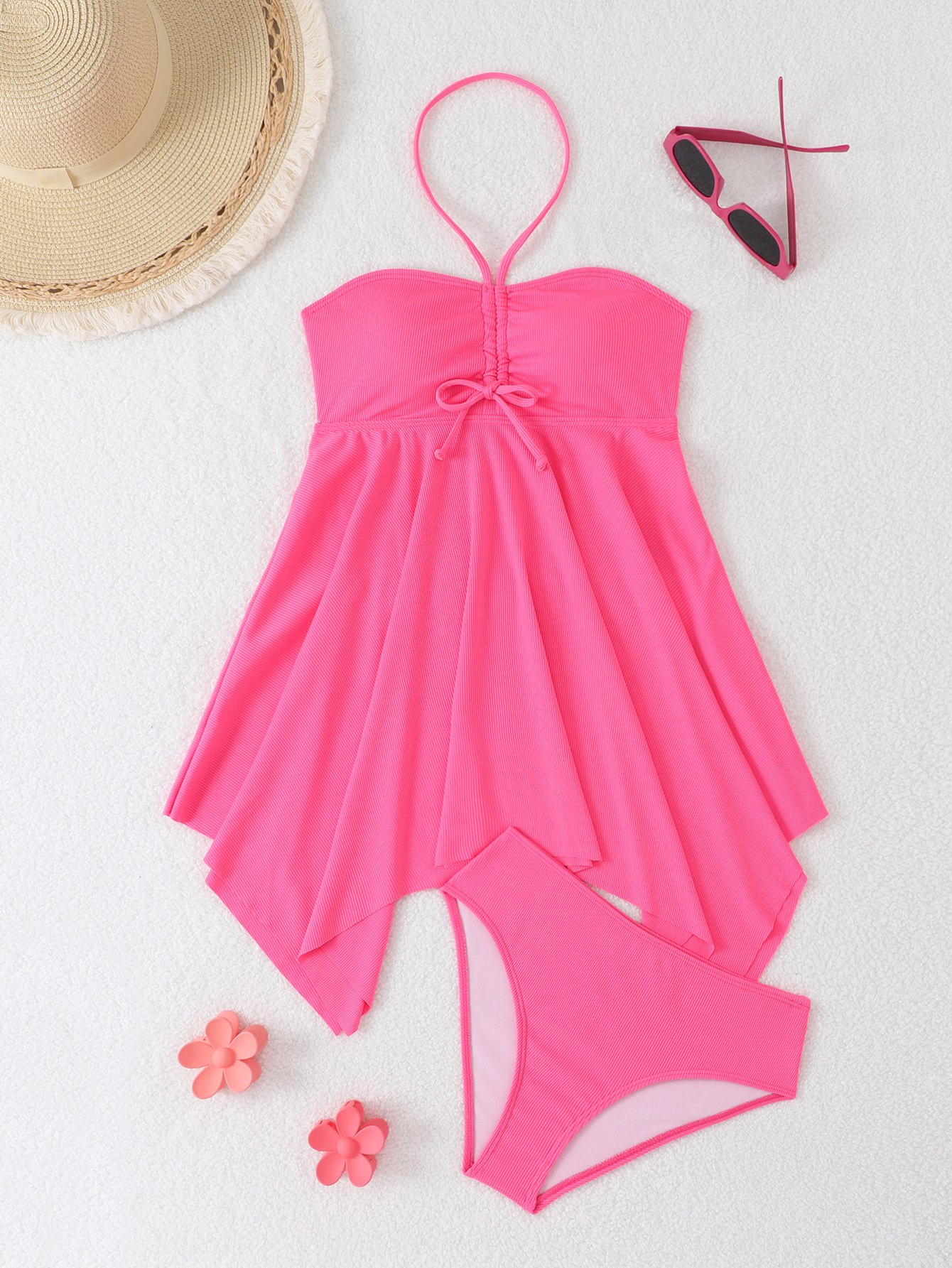 Pink two-piece swim set featuring a halter dress top with front ruching and an asymmetrical skirt overlay, paired